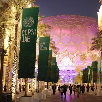 Participants attend day four at night of the UNFCCC COP28 Climate Conference at Expo City Dubai