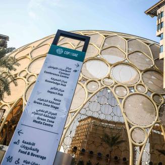 Outdoor scenery with signage from COP28.