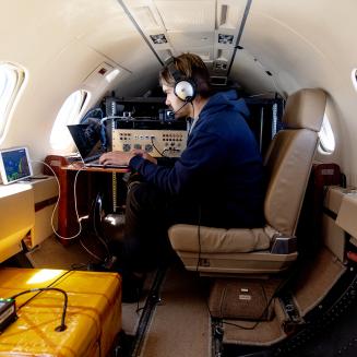 Team member and scientific equipment aboard MethaneAIR.