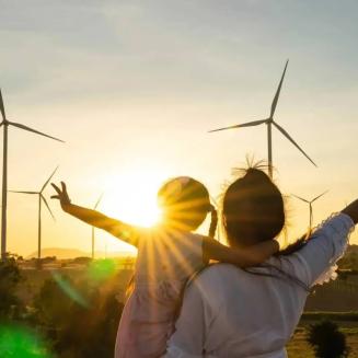 A child and caregiver viewing windmills.
