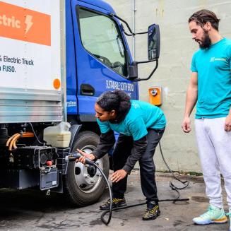 People charging an electric truck.