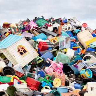 Many pieces of discarded plastic, ranging from baskets to a play house.