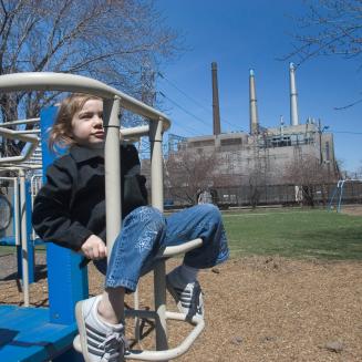 Little girl plays in Belanger Park, next to DTE Energy's coal-fired power plant