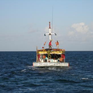 A fishing boat in the middle of the ocean.
