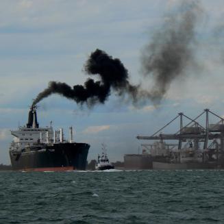 Ship with black emission stream maneuvering out of Port S.Louis du Rhone, near Marseilles