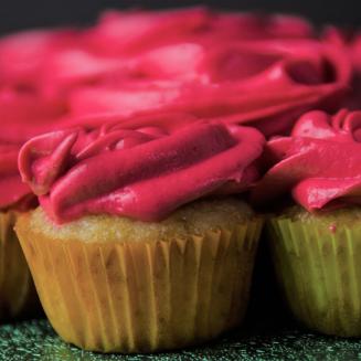 Cupcakes topped with bright red frosting.