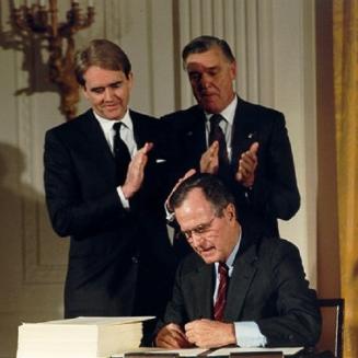 George H.W. Bush signing a document