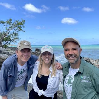 EDF team members outdoors, under a blue sky with a brilliant sea in the background.