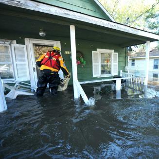 Rescue team entering house during flood