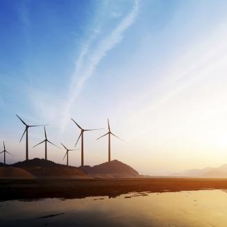 Beach sunset with windmills in the back