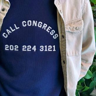 A shirt that reads "Call Congress 202-224-3121"