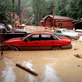 Car slightly submerged in muddy water