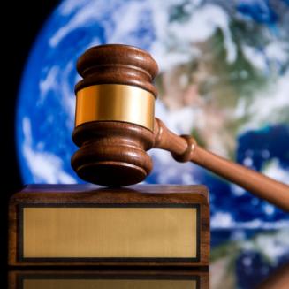 Gavel in front of the earth from spacwe