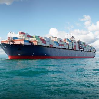 A large ship with shipping containers on it at sea.