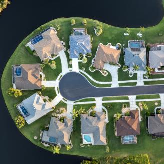 Aerial view of houses in a waterfront community.