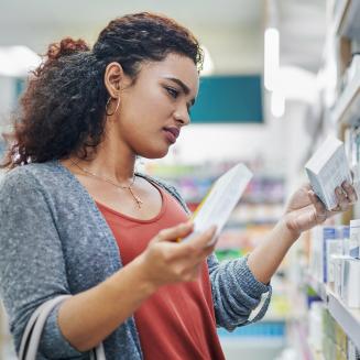 Woman shopping for product in drug store