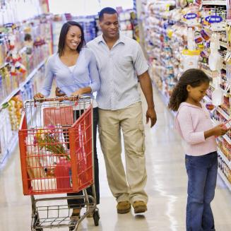Family of three in the cereal aisle at a grocery store
