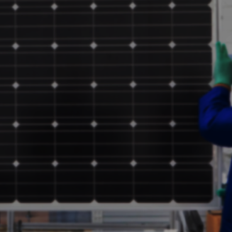 two people carrying a solar panel