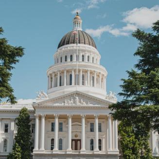 California capitol building surrounded by greenery.