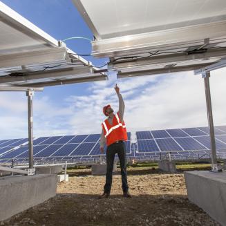 Solar photovoltaic installer examining racking for a PV array