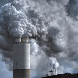 Smoke billows out of a smokestack.