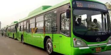 A fleet of green buses parked in a row