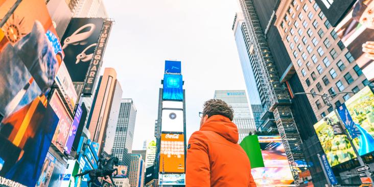 Person in a city looking at billboard advertisements