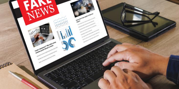  Close up of a person reading fake news on a laptop