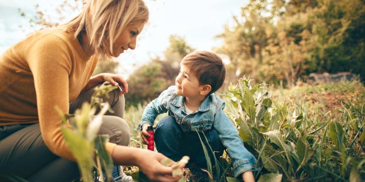 Mother and child planting in nature