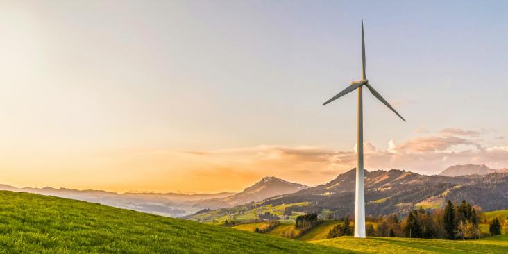 Wind turbine with scenic mountains in background