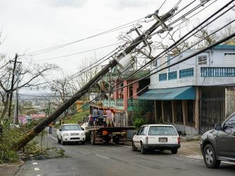 A toppled power line blocks a street in Puerto Rico