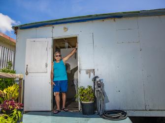 Roberto Rexach stands in the doorway of his home in Culebra, Puerto Rico