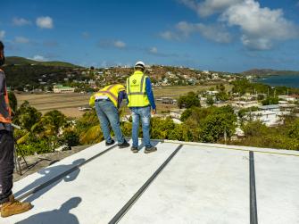 Solar installers on the roof of Roberto Rexach's home in Culebra, Puerto Rico