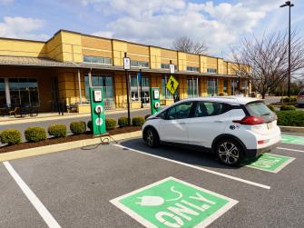 An electric car charging at a charging station