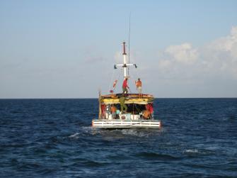 A fishing boat in the middle of the ocean.