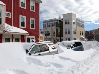 Snow covered cars on a city street