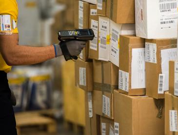 Warehouse worker scanning shipping boxes