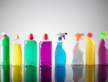 Various multicolored bottles of household cleaning products