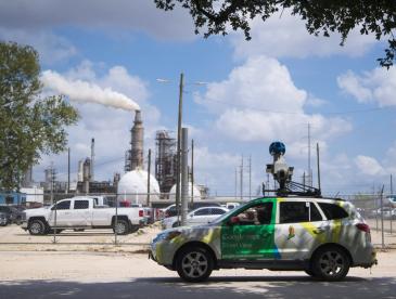 Google Street View car outfitted with air quality monitoring equipment, a dirty smokestack in the background