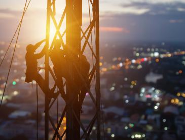 Workers climbing a tower