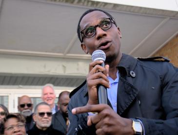 Cleveland mayor Justin Bibb speaking into a microphone.