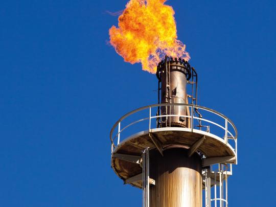Methane flare on a smokestack 