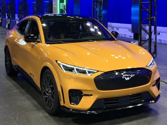 A yellow electric Ford Mustang
