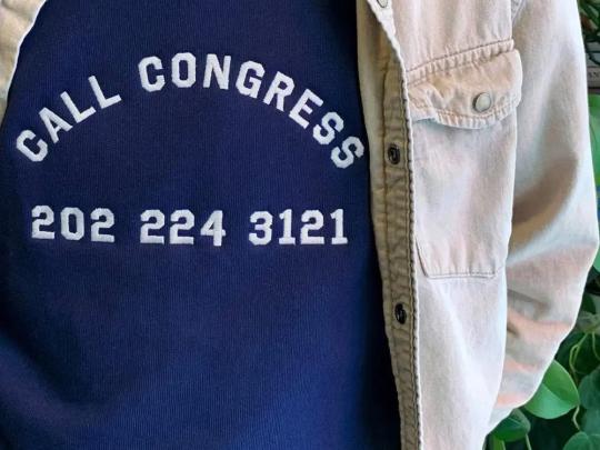 A shirt that reads "Call Congress 202-224-3121"