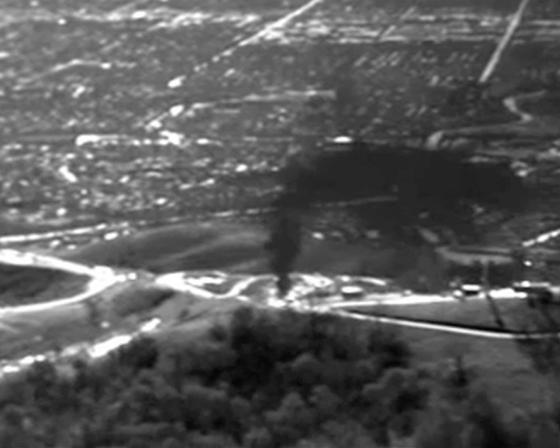 A dark plume drifts into the sky. In 2015, EDF flew over the Aliso Canyon gas leak with an infrared camera to document the pollution.