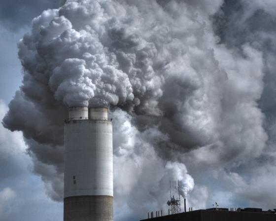 Smoke billows out of a smokestack.