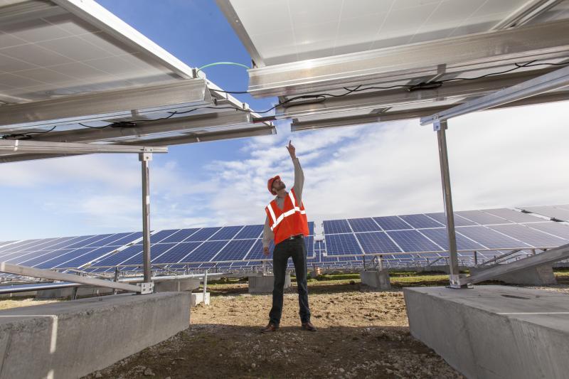 Solar photovoltaic installer examining racking for a PV array