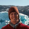 Mattias Cape standing in front of a glacier