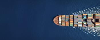 Cargo ship traveling on open water.