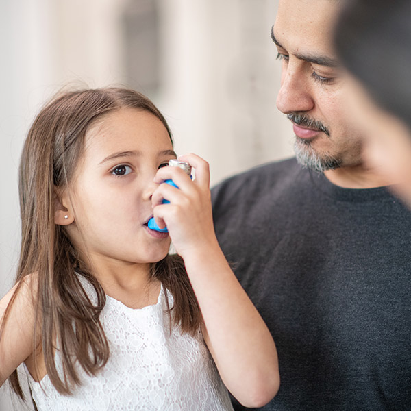 Girl using inhaler